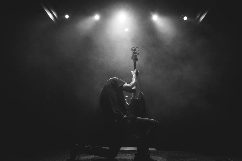 musician playing a guitar solo, black and white