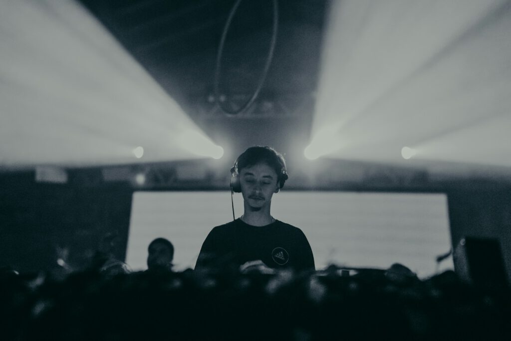 a woman with headphones standing in front of a crowd